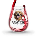 Wine glass with dog cartoon and wine pouring.